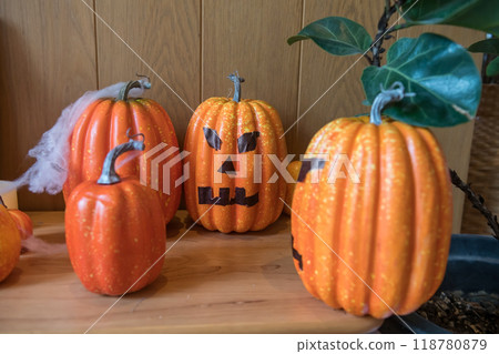 Artificial pumpkin decor on table for Halloween interior 118780879