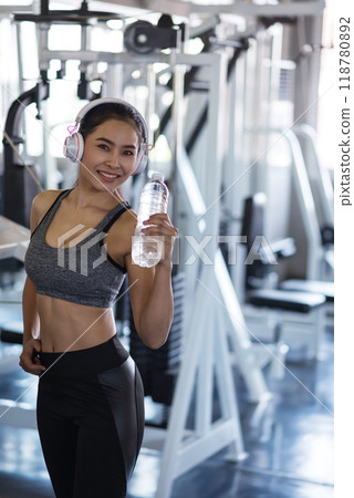smile healthy Asian girl break after exercise in fitness gym smile healthy Asian girl break after exercise in fitness gym 118780892