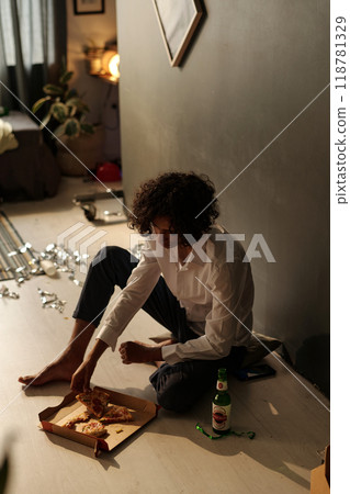Sick guy taking slice of takeaway pizza 118781329