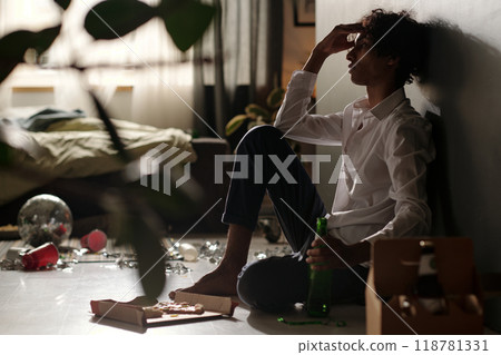Male teenager feeling unwell after party Male teenager feeling unwell after party 118781331