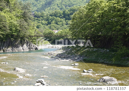 Beautiful green mountains and clear streams Suspension bridge 118781337