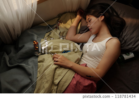 Restful woman napping after booze party 118781434