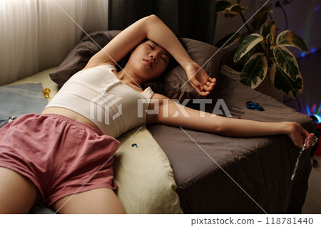 Suffering from splitting headache on bed 118781440