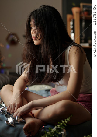 Sitting on bed after booze party 118781450