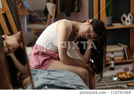 Young stressed woman sitting on bed 118781460
