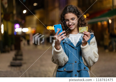 Girl using credit bank card smartphone transferring money purchases online shopping booking hotel 118781475