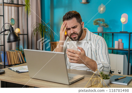 Business man using smartphone bad news lottery game results fortune loss fail at home office 118781498