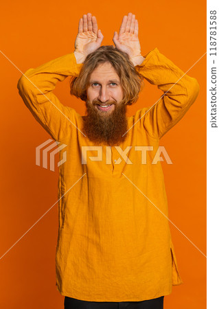 Funny man smiling friendly and doing bunny ears gesture having fun fooling, easter holidays 118781588