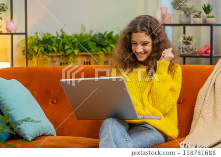 Amazed teen girl use laptop computer, receive good news message, shocked by victory, celebrate win Amazed teen girl use laptop computer, receive good news message, shocked by victory, celebrate win 118781688