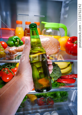 Man taking beer from a fridge 118782242