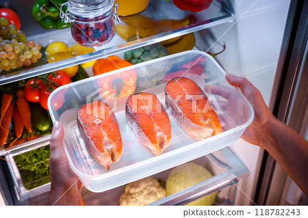 Raw Salmon steak in the open refrigerator 118782243