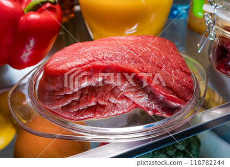 Fresh raw meat on a shelf open refrigerator 118782244