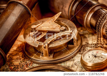 Vintage style travel and adventure. Vintage old compass and other vintage items on the table. 118782248