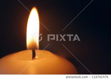 lit candle with black background 118782476