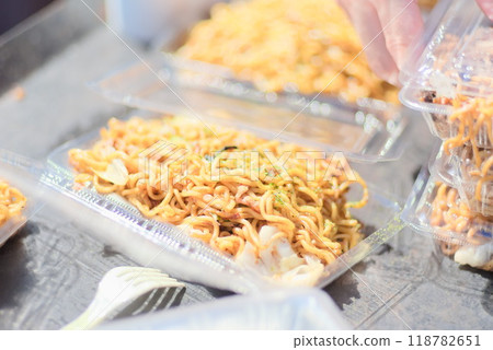 Recreating the taste of the festival: Fried noodles served in containers from a hot plate Recreating the taste of the festival: Fried noodles served in containers from a hot plate 118782651