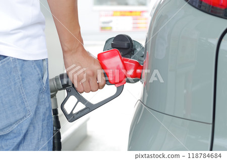 Man filling up his car with gas (no face) 118784684
