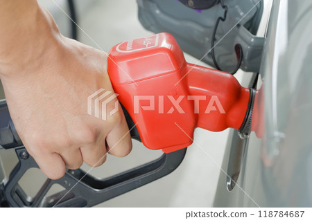 Man filling up his car with gas (no face) 118784687