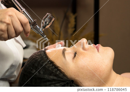 Aesthetician perform jet peeling facial treatment Aesthetician perform jet peeling facial treatment 118786045