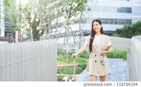 Business asian woman with luggage using digital tablet work and travel at station platform on day Business asian woman with luggage using digital tablet work and travel at station platform on day 118786184