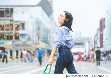 Young adult asian woman wear wireless headphone urban people lifestyles with positive self love Young adult asian woman wear wireless headphone urban people lifestyles with positive self love 118786483
