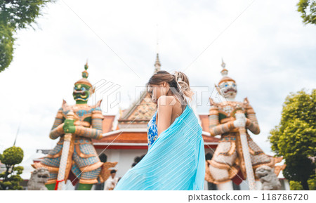 Rear view woman blue dress cloth standing at Wat Arun temple travel Bangkok Thailand Southeast Asia 118786720