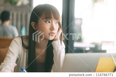 Portrait of young adult asian student woman using laptop at cafe for study and work 118786771