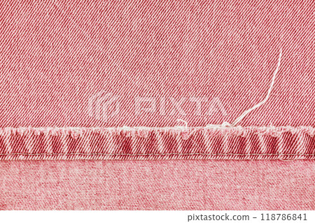Red denim jeans pants edge, ripped stich on jean fabric background, close up, macro. Red denim jeans pants edge, ripped stich on jean fabric background, close up, macro. 118786841