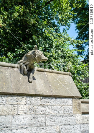 A stone sculpture of a wolf on the wall of Cardiff Castle in Cardiff, the capital of Wales. 118786919