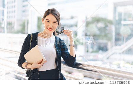 Young adult asian woman using creadit card and smartphone for online shopping and digital wallet 118786968