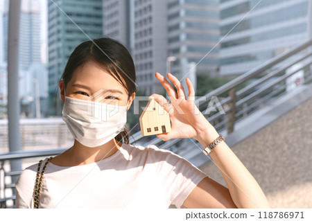 Focus on hand holding house model by young adult investor business woman. Focus on hand holding house model by young adult investor business woman. 118786971