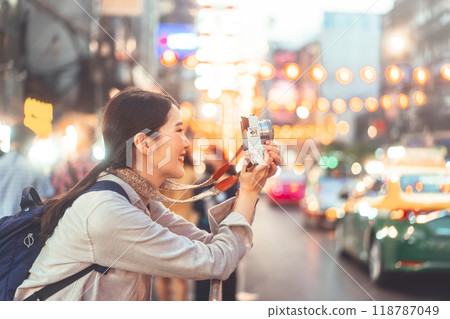 Young adult asian woman traveller backpack using camera photography in city Young adult asian woman traveller backpack using camera photography in city 118787049