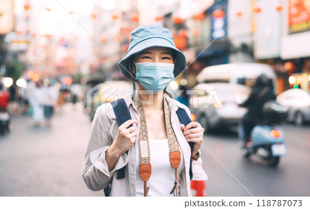 Portrait asian woman backpack traveler wear face mask at Bangkok city Portrait asian woman backpack traveler wear face mask at Bangkok city 118787073