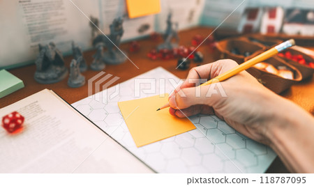 Woman hand writing for create story setup adventure role playing tabletop and board games hobby Woman hand writing for create story setup adventure role playing tabletop and board games hobby 118787095