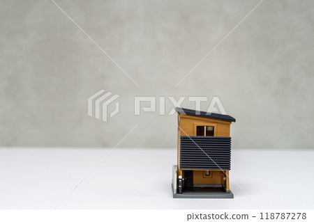 Image of a three-story house with a sloping roof 118787278