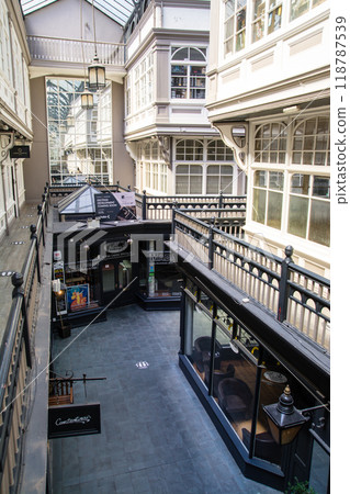 Shops seen from the upper floor of a historic glass-roofed arcade in Cardiff, the capital of Wales 118787539
