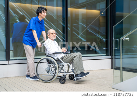 Seniors in wheelchairs having trouble climbing stairs and care facility staff Seniors in wheelchairs having trouble climbing stairs and care facility staff 118787722