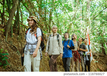 young asian travelers walking around trekking forest young asian travelers walking around trekking forest 118788827
