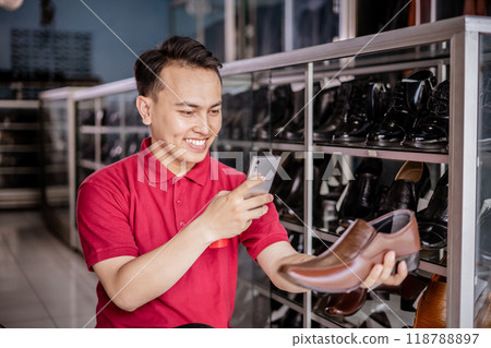 male entrepreneur taking photo brown leather shoes using smartphone 118788897