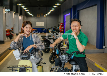 happy asian couple posing riding electric bicycle happy asian couple posing riding electric bicycle 118788966
