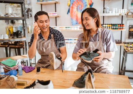 male employee speaking on phone while working male employee speaking on phone while working 118788977