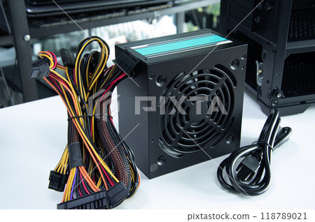 Side view of computer power supply, computer components, motherboard and electrical circuits. 118789021