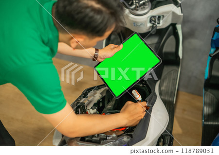 asian male holding copy space tablet fixing bike 118789031