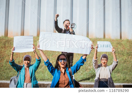 Individuals Assembled in a Protest for Freedom, Holding Signs and Using a Megaphone 118789290