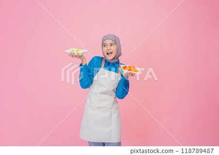 A Delighted Chef Showcasing a Variety of Colorful and Appetizing Dishes Against a Pink Background A Delighted Chef Showcasing a Variety of Colorful and Appetizing Dishes Against a Pink Background 118789487