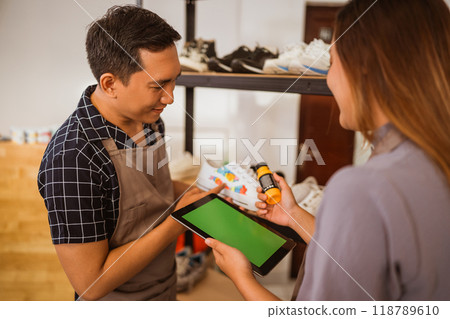 male staff checking paint product on tablet male staff checking paint product on tablet 118789610