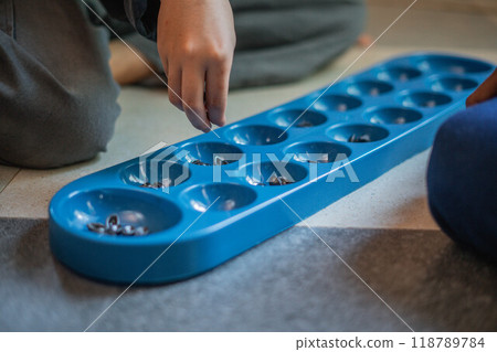 kid hand putting seeds into plastic board kid hand putting seeds into plastic board 118789784
