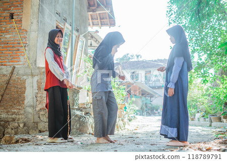 asian hijab kids rope skipping outside house 118789791