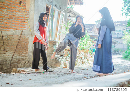 happy hijab kids playing rope skipping outside happy hijab kids playing rope skipping outside 118789805