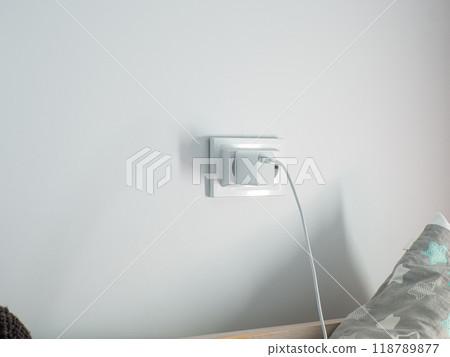 Electrical outlet on a white wall: a conceptual representation of power supply Electrical outlet on a white wall: a conceptual representation of power supply 118789877