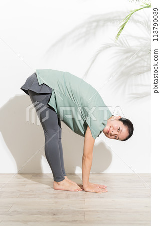 A woman doing flexibility exercises A woman doing flexibility exercises 118790089